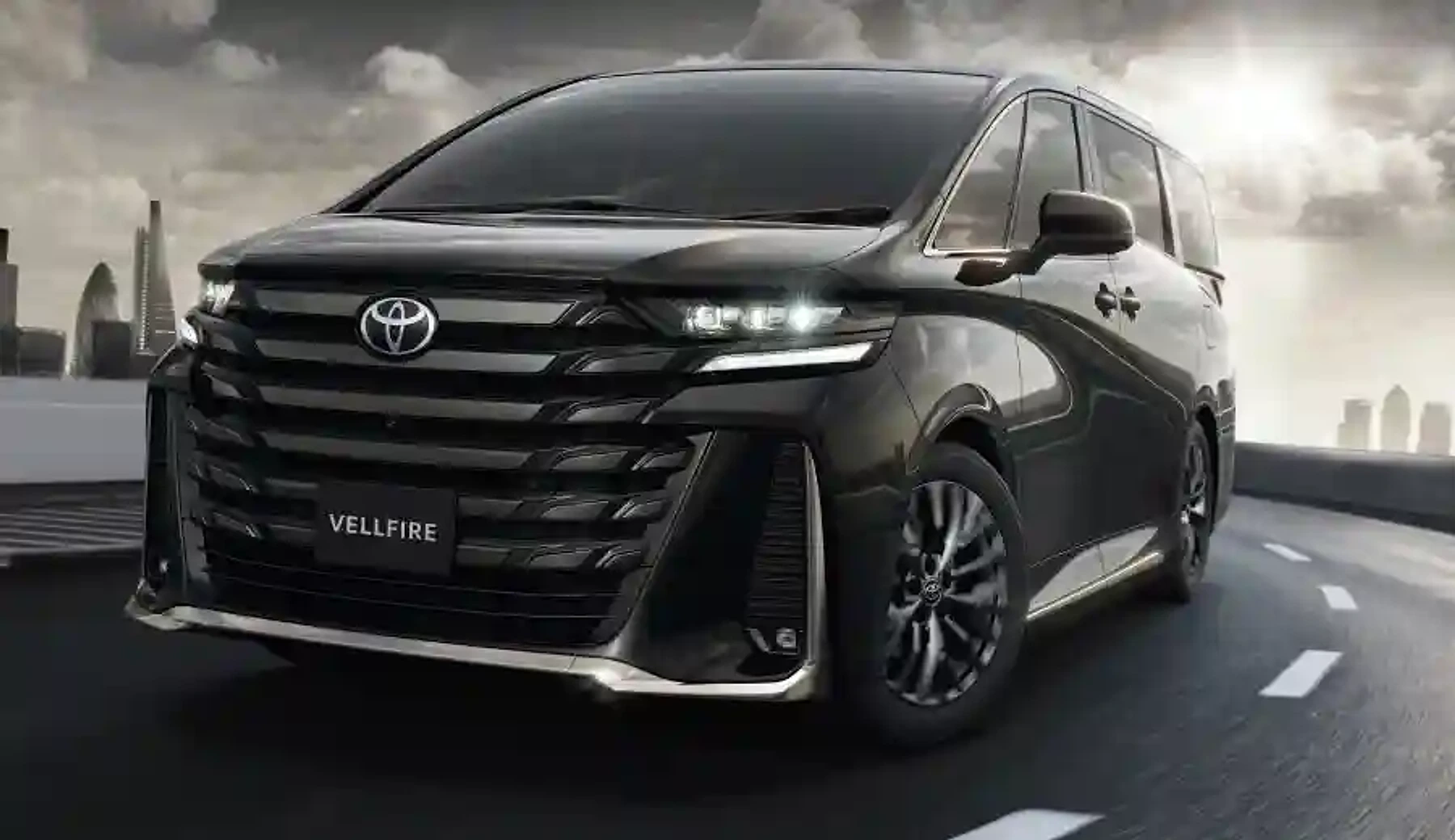 Vellfire on an urban highway at dusk